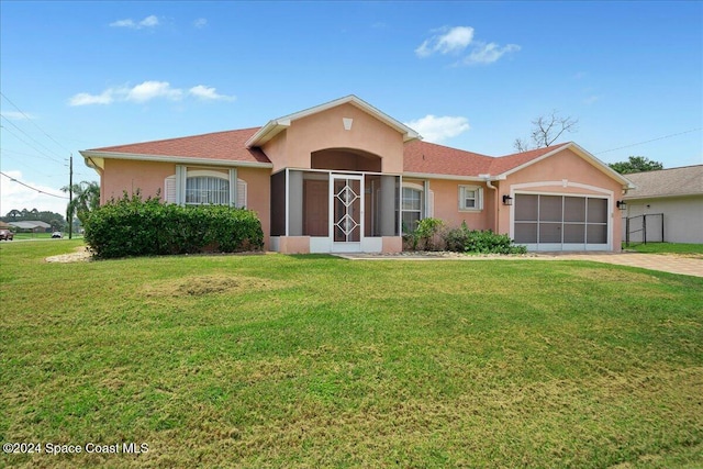 ranch-style home with a front yard and a garage