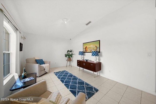 tiled living room featuring lofted ceiling