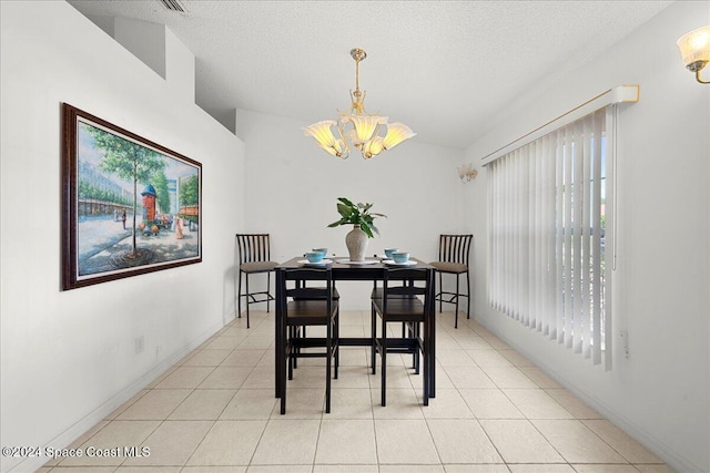 dining space with light tile patterned floors, a textured ceiling, an inviting chandelier, and lofted ceiling