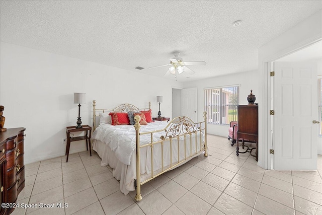 bedroom featuring light tile patterned floors, a textured ceiling, and ceiling fan