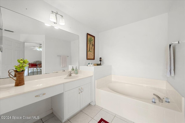 bathroom featuring tile patterned flooring, vanity, ceiling fan, and tiled tub