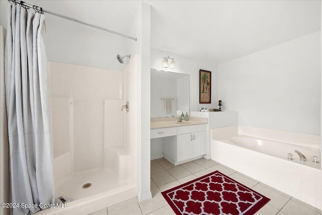 bathroom with tile patterned flooring, vanity, and independent shower and bath