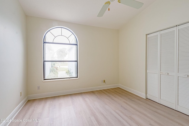 unfurnished bedroom with a closet, light hardwood / wood-style flooring, and ceiling fan