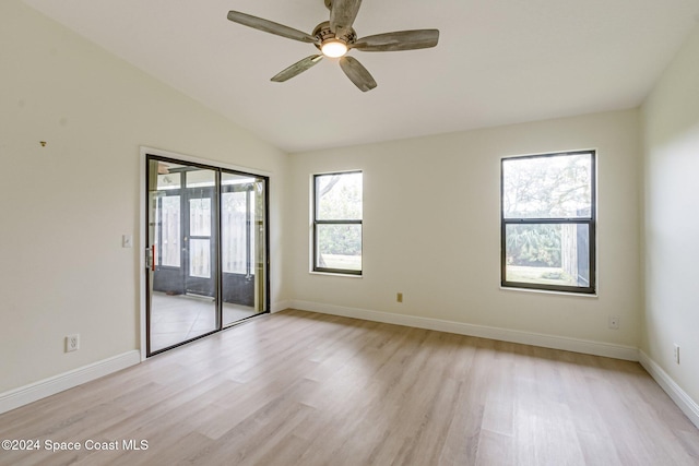 empty room featuring vaulted ceiling, light hardwood / wood-style flooring, and ceiling fan