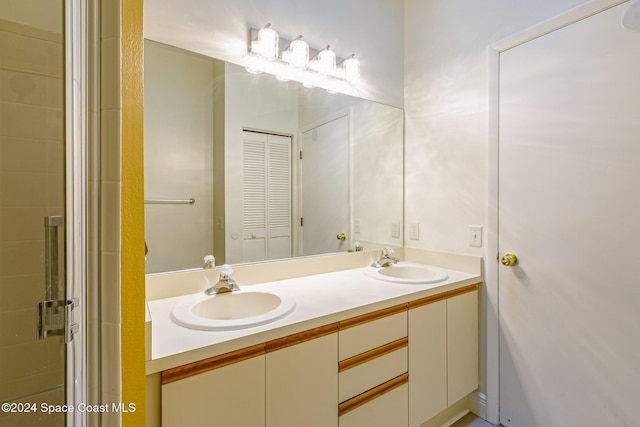 bathroom featuring vanity and a shower with shower door