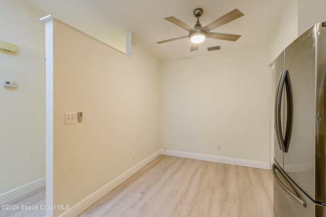 spare room featuring light hardwood / wood-style flooring and ceiling fan