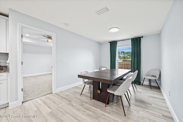 dining space featuring ceiling fan and light wood-type flooring