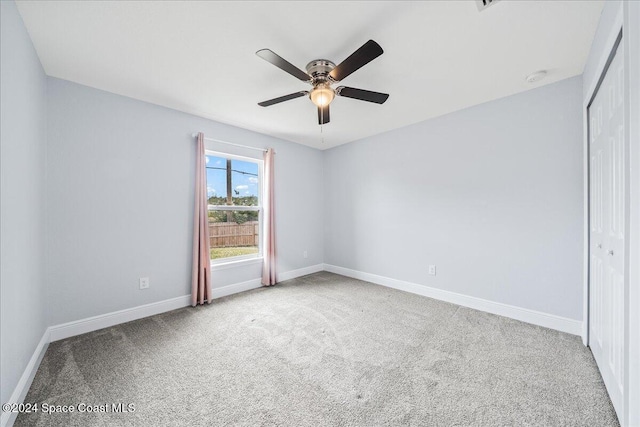 carpeted empty room with ceiling fan