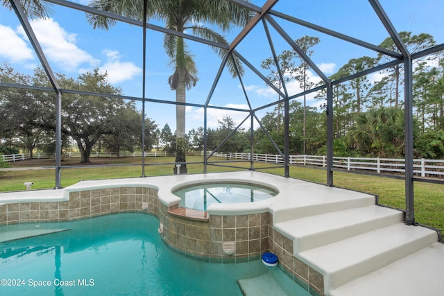 view of pool with a lawn, glass enclosure, and an in ground hot tub