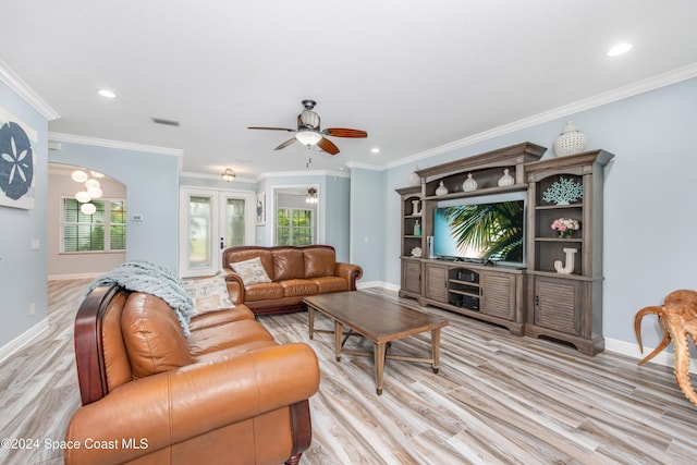 living room featuring plenty of natural light, french doors, and ornamental molding