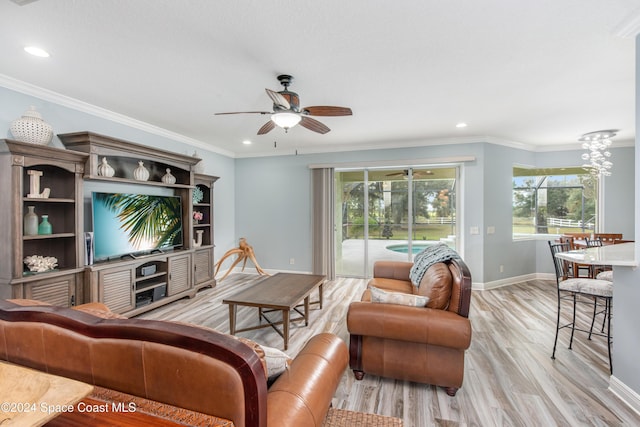 living room featuring ceiling fan, light wood-type flooring, and ornamental molding