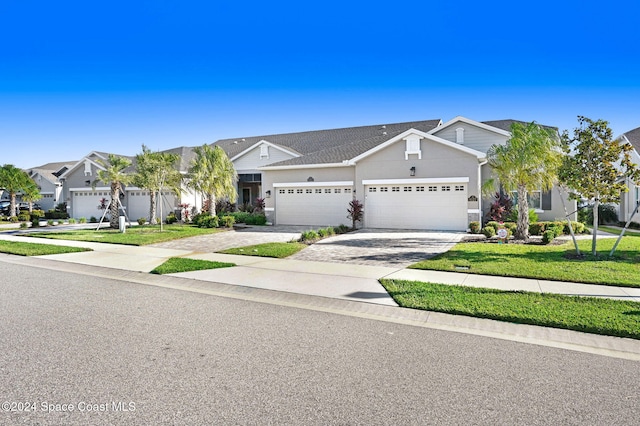 view of front of house with a front lawn and a garage