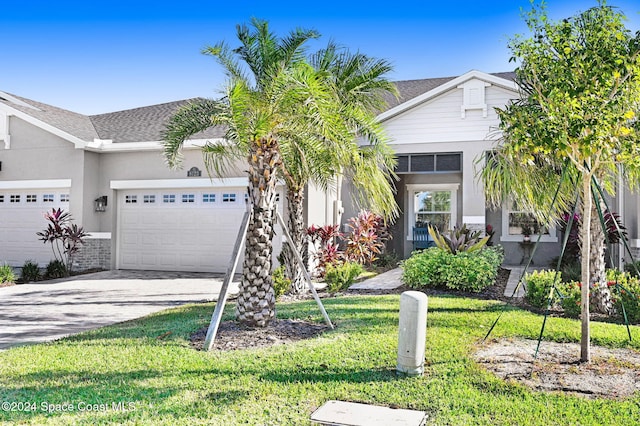 view of front of house featuring a front yard and a garage