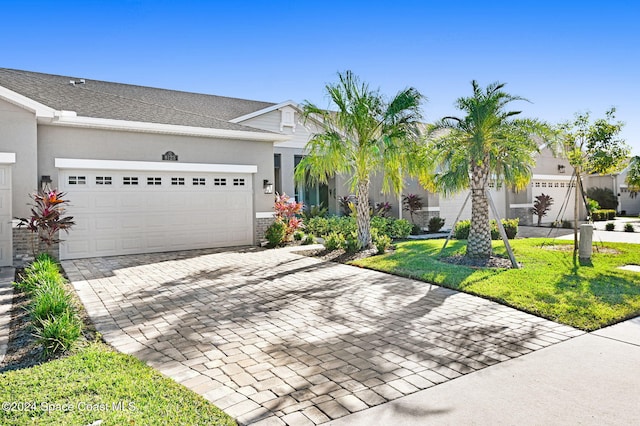 view of front facade featuring a front yard and a garage