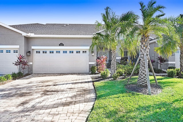 view of front of property with a front yard and a garage