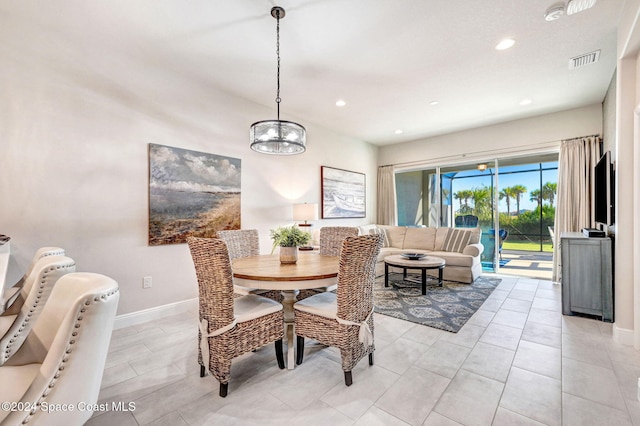 dining area with a notable chandelier and light tile patterned floors