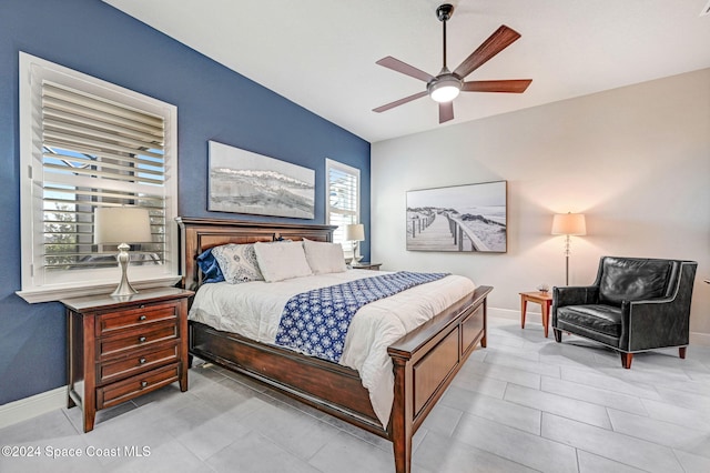 bedroom with ceiling fan and multiple windows