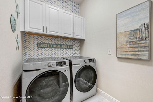 laundry area with cabinets, light tile patterned floors, and separate washer and dryer