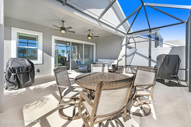 view of patio with ceiling fan, a lanai, and a grill