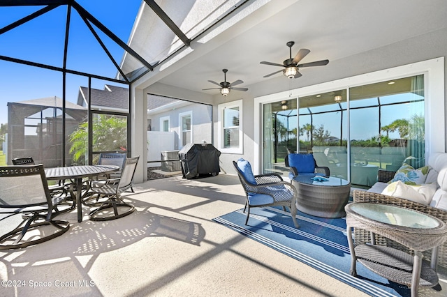 view of patio featuring a lanai, a grill, ceiling fan, and outdoor lounge area