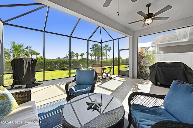 view of patio with area for grilling, ceiling fan, and a lanai