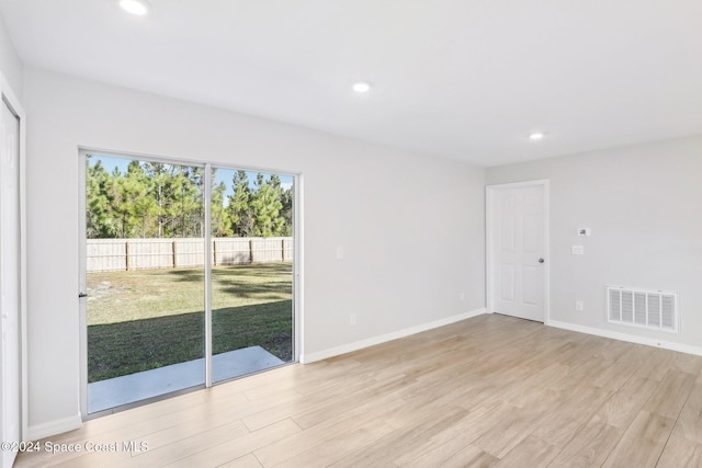 empty room with light hardwood / wood-style flooring