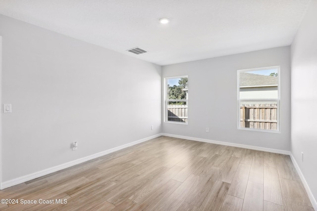 unfurnished room featuring light hardwood / wood-style floors and a healthy amount of sunlight