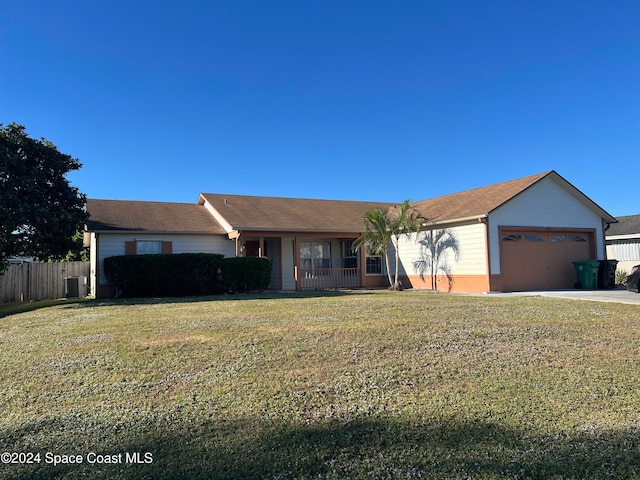 ranch-style house with covered porch, a garage, central air condition unit, and a front lawn