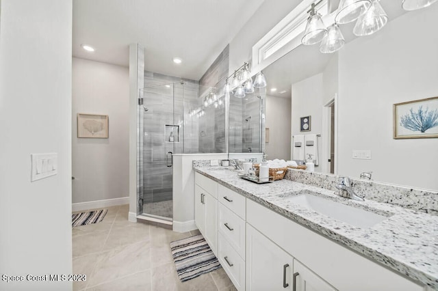 bathroom with a shower with shower door and vanity