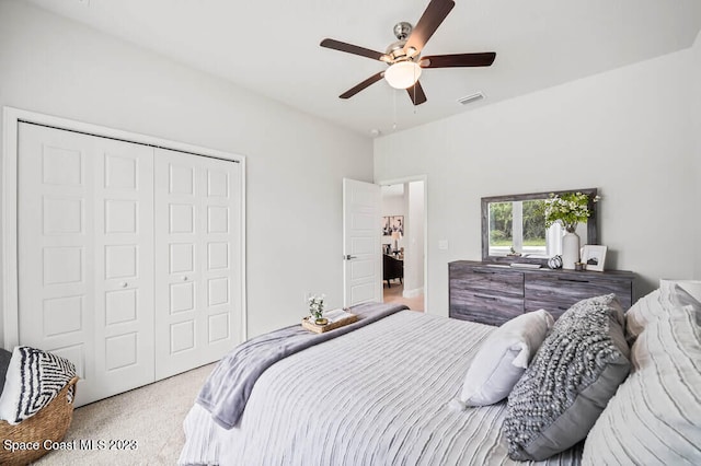 carpeted bedroom featuring ceiling fan and a closet