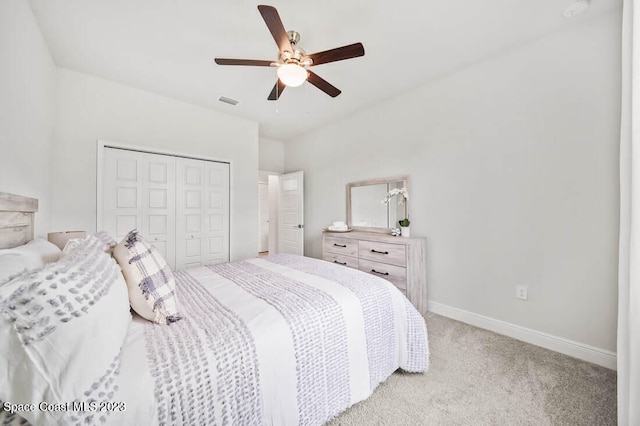 carpeted bedroom featuring ceiling fan and a closet