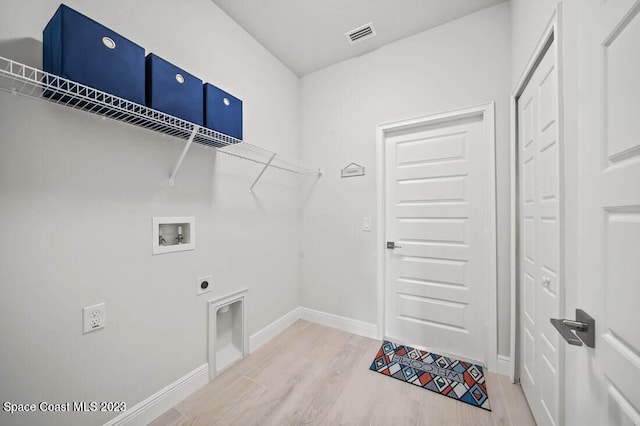 laundry room with electric dryer hookup, hardwood / wood-style floors, and washer hookup