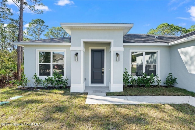 property entrance with a yard