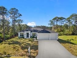 single story home with a front lawn and a garage