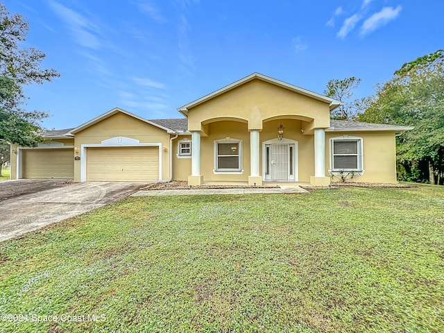 view of front of property with a front yard and a garage