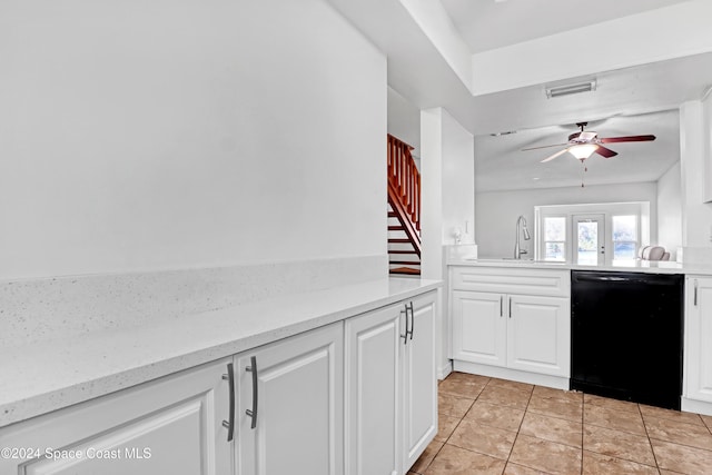 kitchen with white cabinetry, sink, ceiling fan, black dishwasher, and light tile patterned floors