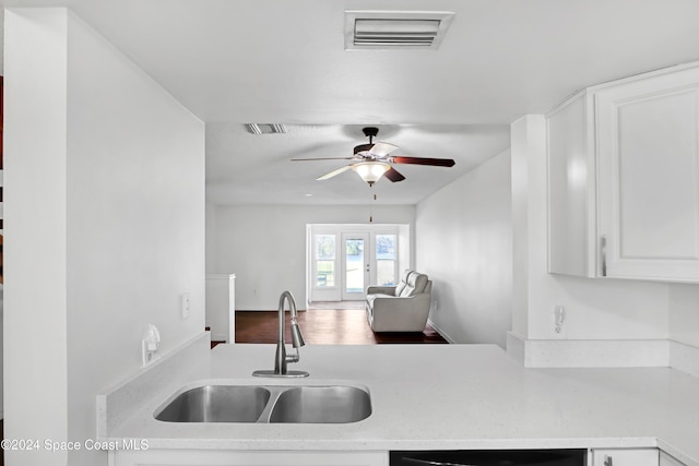 kitchen with ceiling fan, dishwasher, sink, french doors, and white cabinets