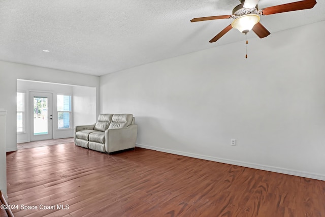 unfurnished room with ceiling fan, hardwood / wood-style floors, and a textured ceiling