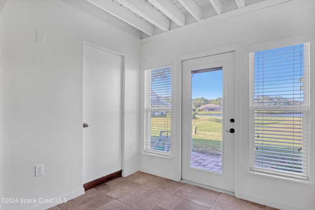 doorway to outside with beamed ceiling