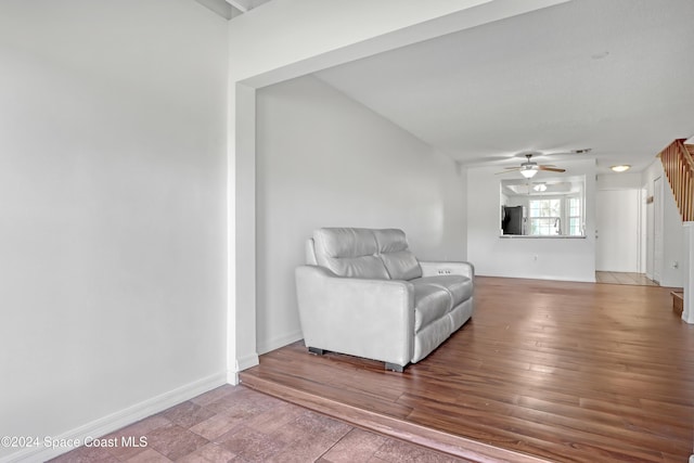 living area with ceiling fan and wood-type flooring