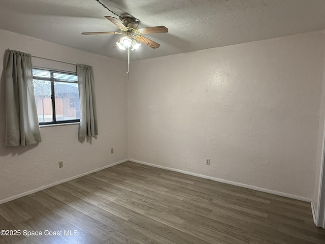 unfurnished room featuring ceiling fan, dark hardwood / wood-style flooring, and a textured ceiling