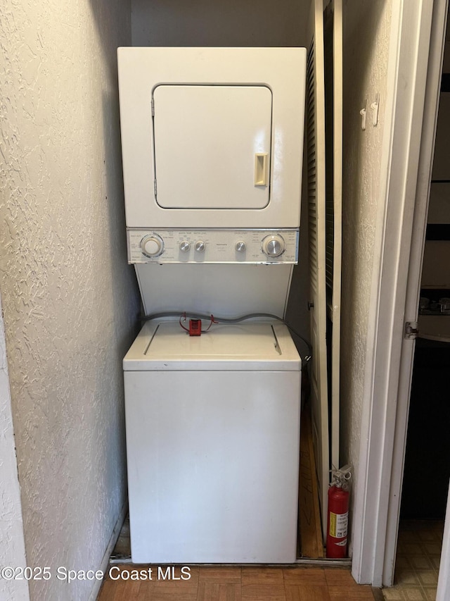 washroom with stacked washer and clothes dryer