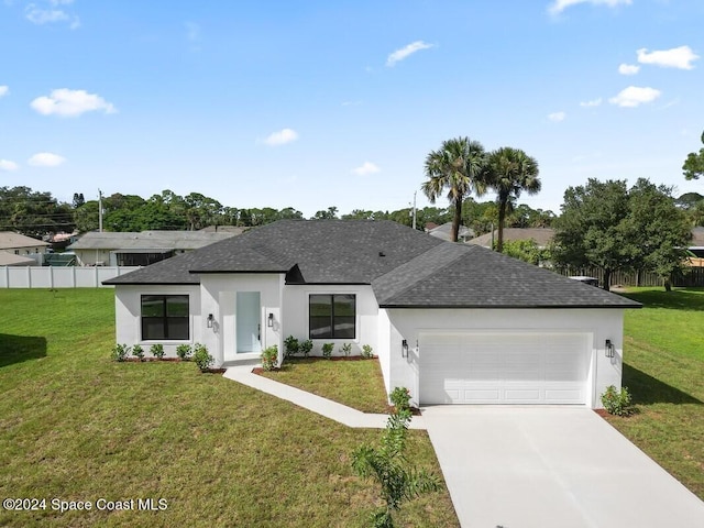 view of front of house featuring a garage and a front lawn