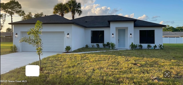 view of front facade with a garage and a front yard