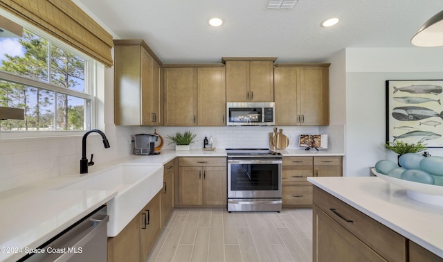 kitchen featuring sink, appliances with stainless steel finishes, and tasteful backsplash