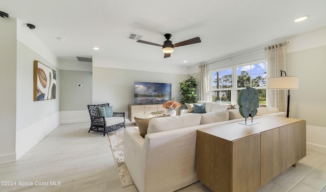 living room featuring ceiling fan and light wood-type flooring