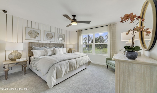 bedroom with ceiling fan and light carpet