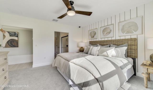 bedroom with ceiling fan and light colored carpet