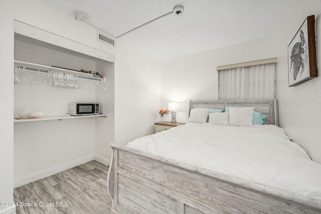 bedroom with hardwood / wood-style flooring