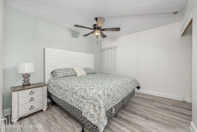 bedroom with hardwood / wood-style floors and ceiling fan